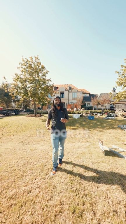 Original first frame: wide shot of a man walking on a lawn